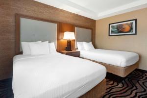 two beds in a hotel room with white sheets at Best Western Summit Inn in Niagara Falls