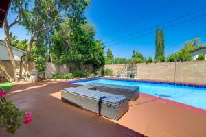 an image of a swimming pool with two beds in a yard at Sleek Woodland Hills Retreat with Shared Pool and Yard in Woodland Hills