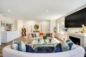 a living room with a couch and a fireplace at Laguna Beach Escape with Hot Tub and Ocean Views! in Laguna Beach