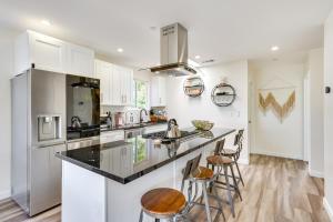 a kitchen with white cabinets and black counter tops at Laguna Beach Escape with Hot Tub and Ocean Views! in Laguna Beach