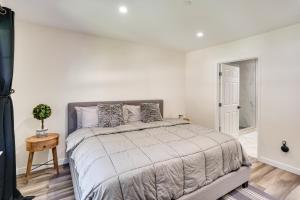 a white bedroom with a large bed and a table at Laguna Beach Escape with Hot Tub and Ocean Views! in Laguna Beach +28 photos