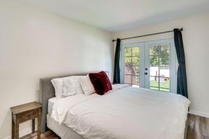 a bedroom with a white bed and a window at Laguna Beach Escape with Hot Tub and Ocean Views! in Laguna Beach