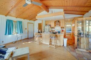 a kitchen with wooden walls and a ceiling with blue curtains at Scenic Kernville Getaway with Deck and Mountain Views! in Kernville