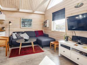 a living room with a couch and a tv at 6 person holiday home in Karrebæksminde-By Traum in Karrebæksminde