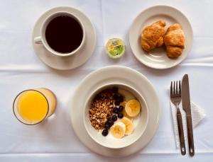 a table with a bowl of breakfast food and a cup of coffee at Casa Hotel Solare de la 70 in Medellín