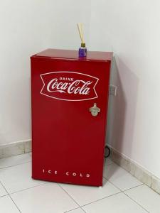 a red coke cola machine sitting on the floor at Habitacion independiente muy bien ubicado in Cartagena de Indias