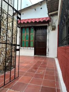 an entrance to a building with a gate and a brick floor at Habitacion independiente muy bien ubicado in Cartagena de Indias
