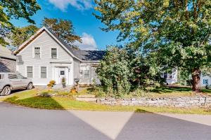 a white house with a car parked in the driveway at Harbor House in Boothbay Harbor