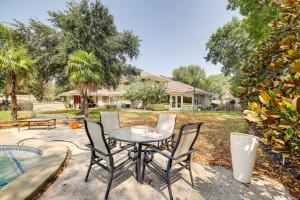 a patio with a table and chairs and a pool at Cozy Houston Studio with Pool Access! in Houston