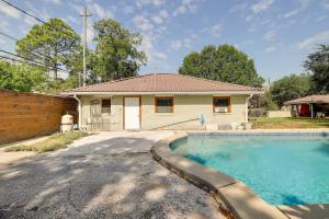 a house with a swimming pool in front of it at Cozy Houston Studio with Pool Access! in Houston
