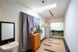 a bathroom with a sink and a mirror and a sink at Stradford Stay Melaka in Melaka
