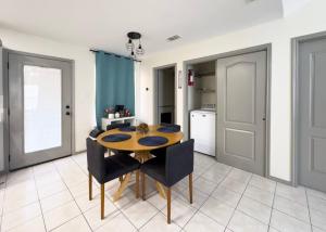 a kitchen and dining room with a table and chairs at Chic, Quiet 2BR 2BA Near Shops & Restos! in McAllen