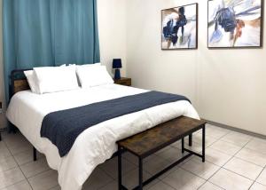 a bedroom with a bed and two pictures on the wall at Chic, Quiet 2BR 2BA Near Shops & Restos! in McAllen
