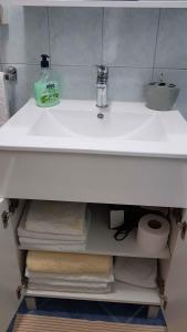 a bathroom sink with a lot of towels under it at Apartment in Lopar/Insel Rab 17757 in Lopar