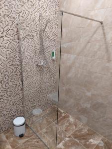 a bathroom with a glass shower with a toilet at Sweet villa Palanga in Palanga