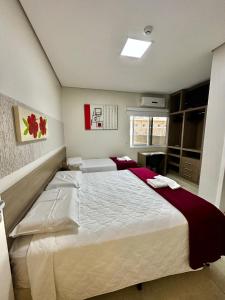 a bedroom with a large bed in a room at Hotel Imperatriz in Telêmaco Borba