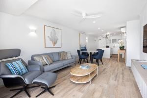 a living room with a couch and a table at Commodore Apartment 5, Noosa Heads in Noosa Heads