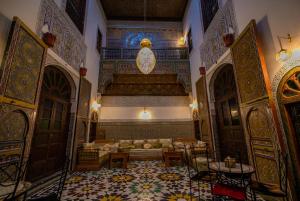 a living room with a couch in the middle of a building at Riad Qamar Fez in Fès