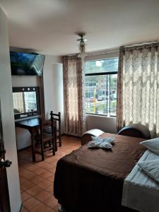 Postel nebo postele na pokoji v ubytování LAS ARTES INN