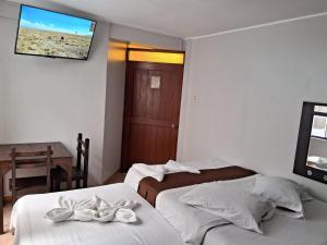 Postel nebo postele na pokoji v ubytování LAS ARTES INN