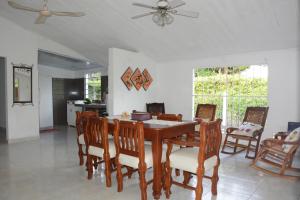 a dining room with a wooden table and chairs at VILLA ALEJANDRIA - CABAÑA LAMARIQUITA-CABAÑA ORQUIDEA-CABAÑA CARAMBOLa in Mariquita