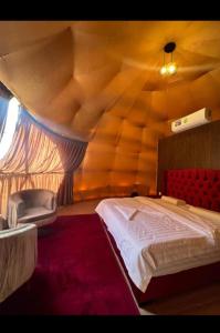 a bedroom with a large bed in a tent at Hilton Wadi rum in Disah