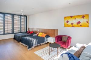 een woonkamer met 2 bedden en een bank bij Signature Design Estate in Cieneguita