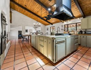 a large kitchen with a large island in the middle at Scenic Spanish Rancho - Breathtaking Views in Three Rivers