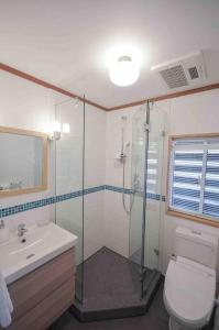 a bathroom with a shower and a toilet and a sink at Hakuba Colonsay- Amazing views 3bdr 2bth cottage in Hakuba +34 photos