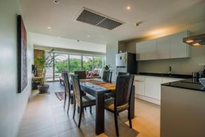 a kitchen and dining room with a table and chairs at Daisy 2 Bed Amazing Seaview in Rawai Beach
