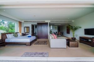 a living room with a bed and a couch at Daisy 2 Bed Amazing Seaview in Rawai Beach