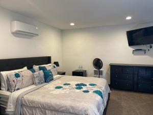 a bedroom with a bed and a flat screen tv at CASTLE ROCK in Flagstaff