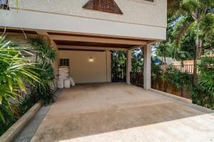 a patio of a house with palm trees at Orchid Pool Villa in Rawai in Rawai Beach