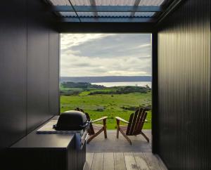 um quarto com uma varanda com vista para um campo em CABN Kangaroo Island em Penneshaw