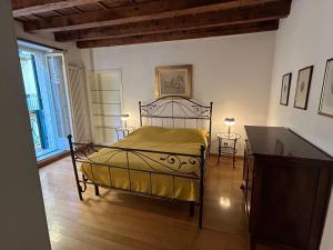a bedroom with a metal bed with two tables at Casa dei Mercanti in Verona