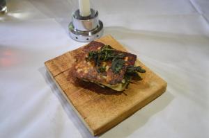 a piece of food on a cutting board on a counter at Jädra Gårdshotel in Enköping