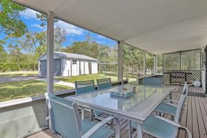 a patio with a table and chairs on a deck at Tabitha Hill Cottage close to wineries and nature in Bellbird