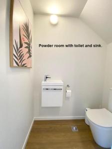 a bathroom with a toilet and a sink at Stunning Townhouse - Walking to Botany Shopping Center in Auckland
