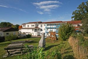 a park with a playground in front of a building at Residenz Binz - FeWo 16 in Binz