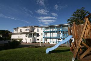 a apartment building with a blue slide in front of it at Residenz Binz - FeWo 16 in Binz