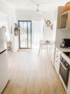 a kitchen with a wooden floor and a table at Beach Bungalow Yeppoon in Yeppoon