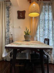 a dining room table with a potted plant on it at Mận Đào Villa in Ho Chi Minh City