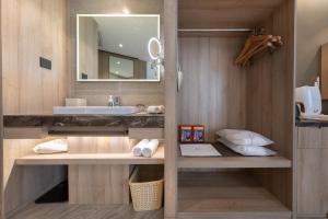 a bathroom with a sink and a mirror at Atour Hotel Lanzhou Xiguan Zhengning Road in Lanzhou