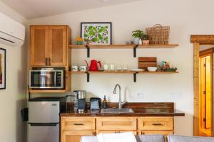 a kitchen with wooden cabinets and a sink at Backwoods Cabins in Carson