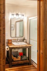W łazience znajduje się umywalka i lustro. w obiekcie Backwoods Cabins w mieście Carson