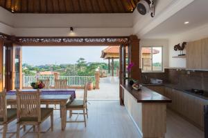 a kitchen and dining room with a table and chairs at Villa Sari Tagtag Bali in Sanur