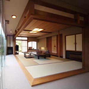 Habitación grande con mesa y bancos. en Ryokan Ichinomatsu en Hakodate