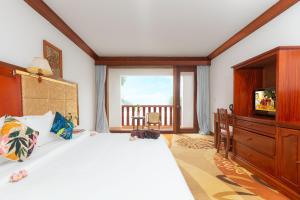 a bedroom with a large bed and a television at Angkor Land Urban Boutique in Siem Reap