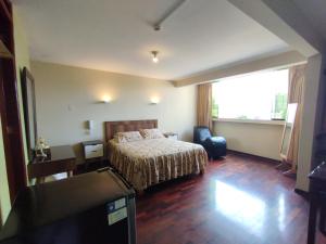 a hotel room with a bed and a large window at Montreal Hostal in Lima