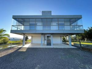 a house with a balcony on top of it at Kitnet beira da lagoa in Terra de Areia +18 photos